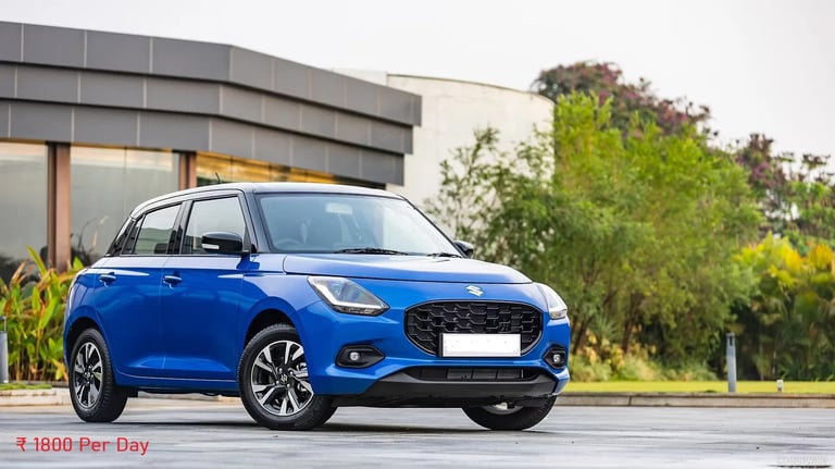 self-drive-car-rental- blue maruti swift car parked in front of a building