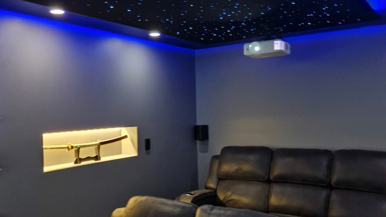 a cinema room with a star light ceiling