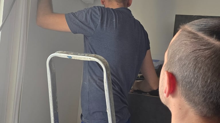 Repairing a refrigeration leak on a wall-mounted unit.