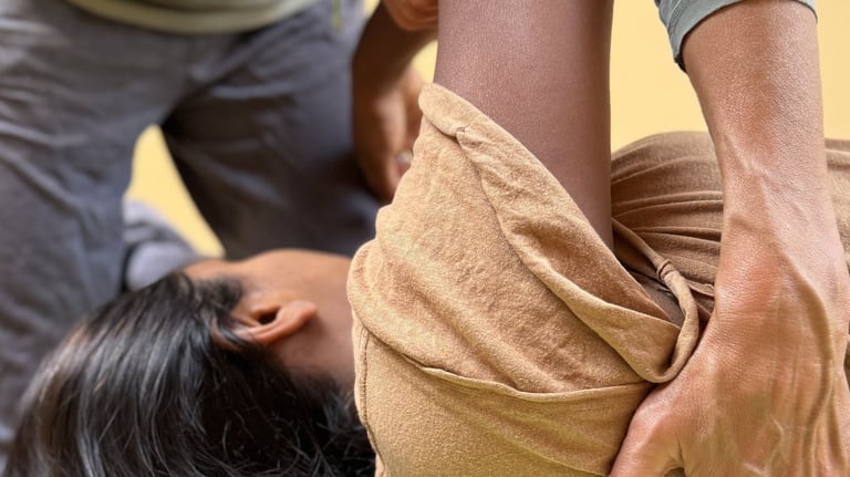 a woman is being gently moved in an individual Functional Integration session