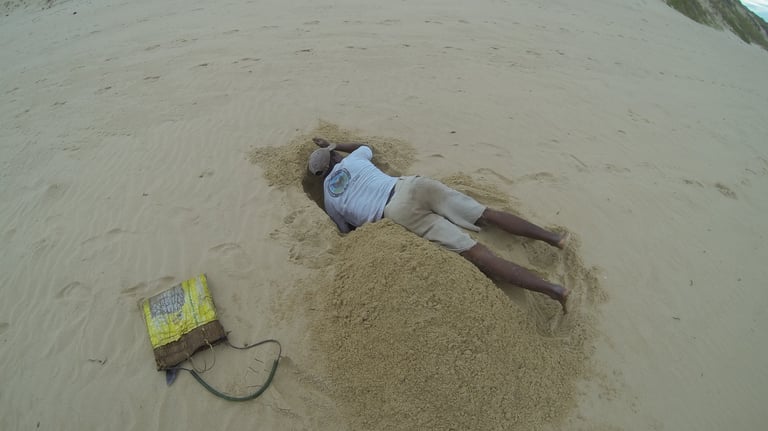 man digging for crustaceans at tofo Beach, Praia do Tofo, Mozambique