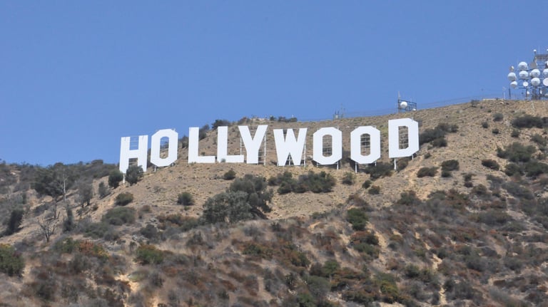 a large hollywood sign on a hill with a blue sky in the background