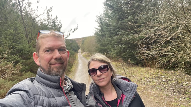 nick and tracey billington on the footpath through the woods on Moel Famau, wales