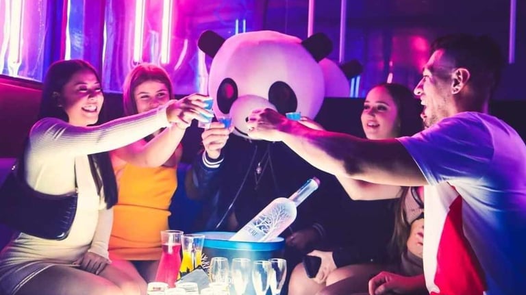 a group of people sitting around a table with drinks