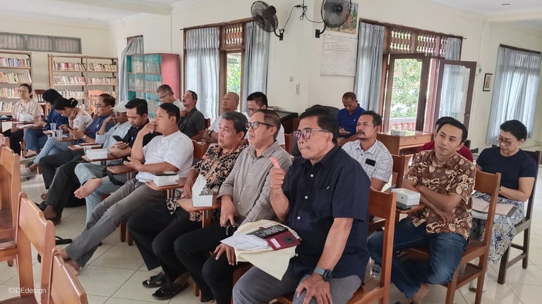 a group of DPP DKP Paroki Tuka sitting in chairs in a room