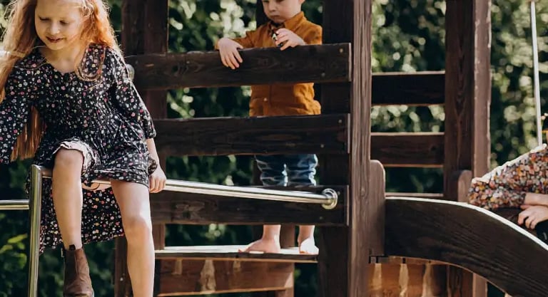 maman s'amusant avec ses enfants sur une cabane en bois