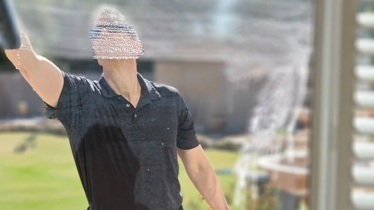 man washing a home window