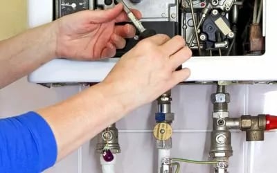 a person is fixing a water heater