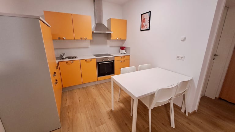 a kitchen with a table and chairs in the middle of the room
