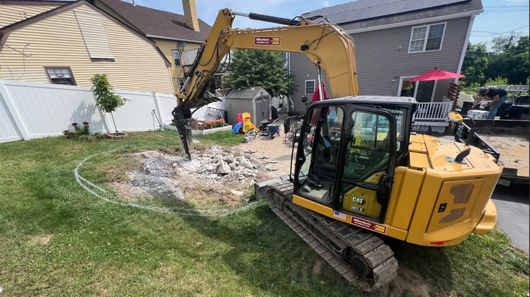 Photo of an excavator working in a yard