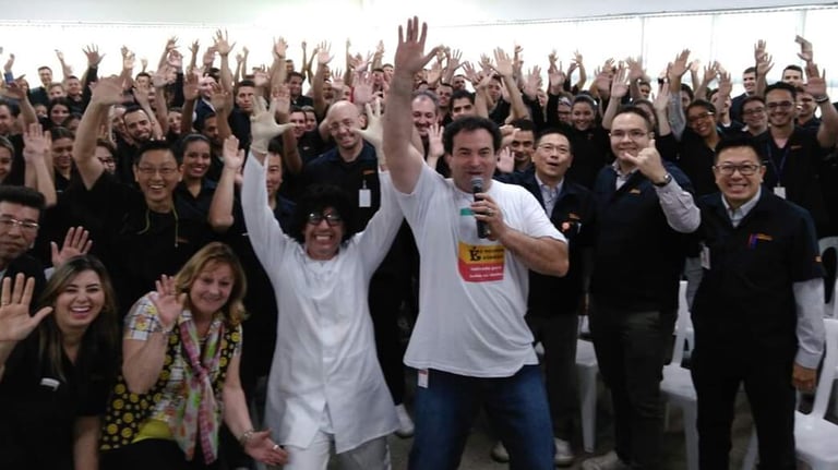 a group of people standing in front of a crowd of people