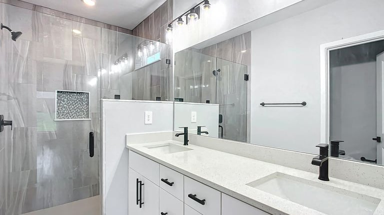 Modern bathroom renovation in Kissimmee with luxury tiling, custom vanity, and updated lighting by F