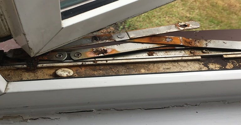 Picture of a broken upvc window hinge.