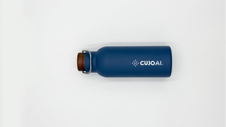 A blue CUJO AI branded insulated stainless steel water bottle with a wooden cork cap on a white background.