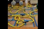 a dog is laying on the floor with a hose