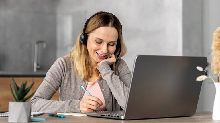 a woman in headphones and headphones is sitting at a desk