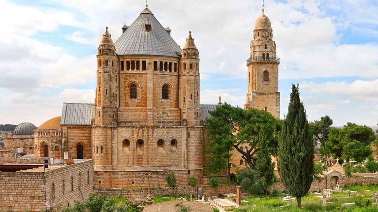 Dormition Abbey at Mount Zion, Jerusalem against a cloudy blue sky
