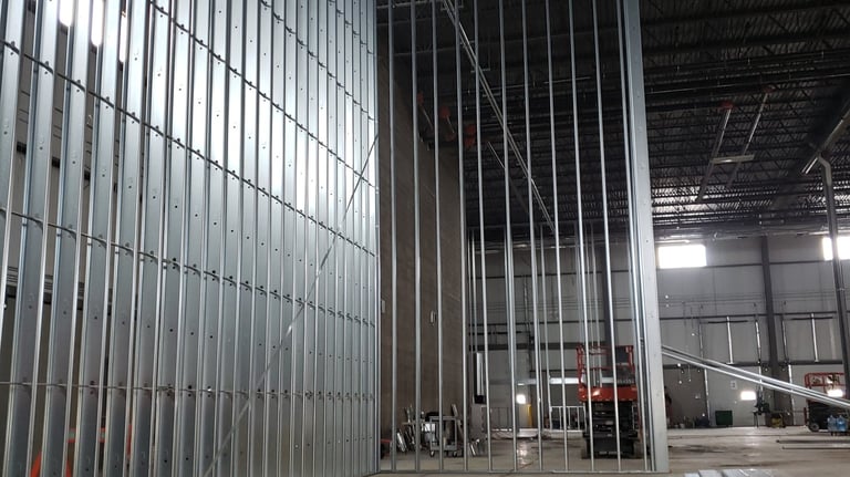 Interior steel stud framing installed for commercial construction prior to drywall and ceiling insta