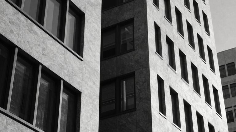 Black and white photography of a modern architectural detail in a North American corporate building, focusing on sharp geometric lines and shadows to represent discipline and structure.
