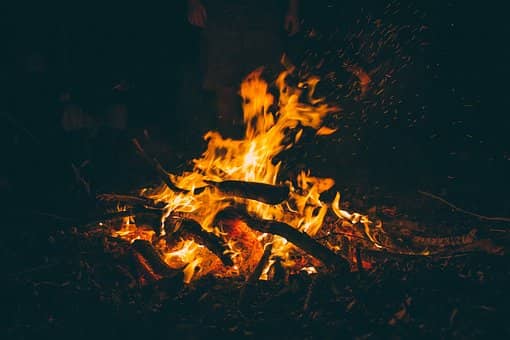 A flame glowing against a dark background, evoking warmth and transformation