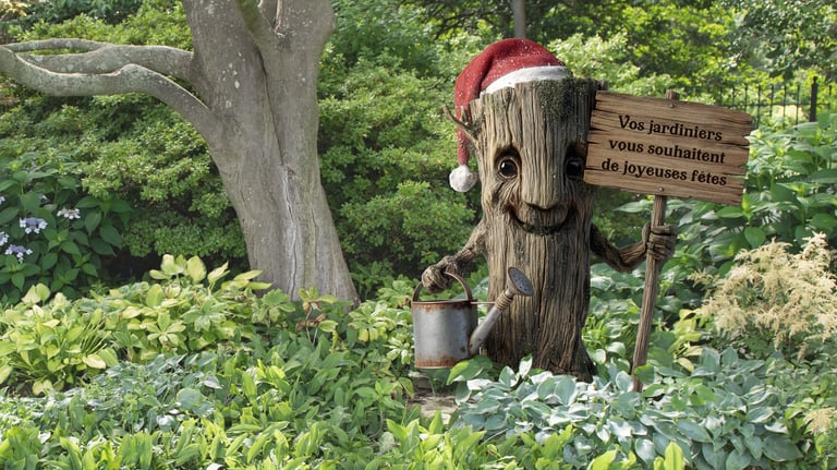 PLV, décoration. Un personnage en tronc d'arbre en PVC qui tient une pancarte dans un jardin.