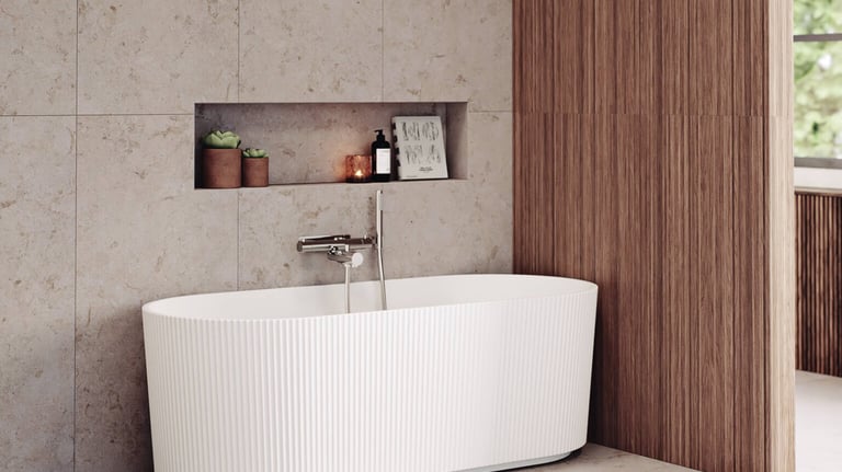 Modern white fluted freestanding bathtub in a luxury bathroom with beige stone tiles and wood wall paneling.