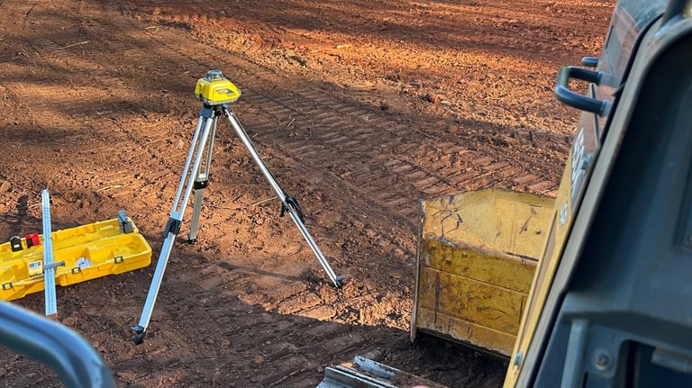 Laser level grading building pad