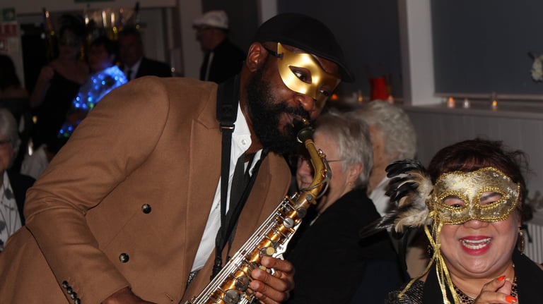 Professional saxophonist performing at intimate London nightclub with warm ambient lighting