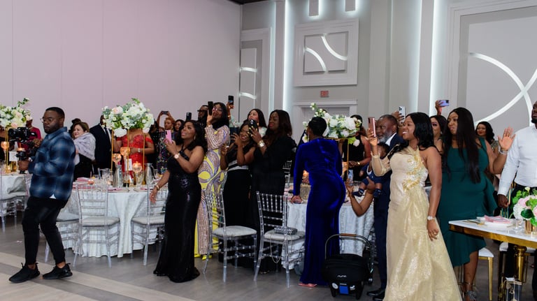 A picture of attendees of a Luxelite event with people capturing the moment with their phones.