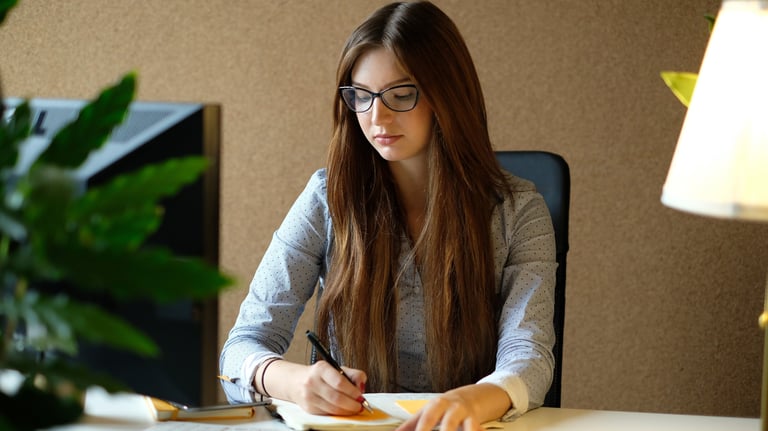 Estudiante universitaria realiza apuntes en su libreta