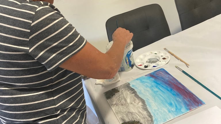 a woman is painting a picture of a painting