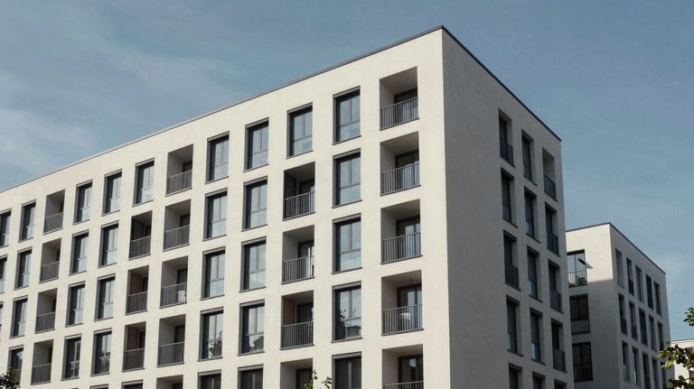 A professional architectural shot of a modern apartment building exterior in Magdeburg, showing high-quality construction under a clear sky.