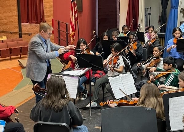 String Orchestra Director in rehearsal.