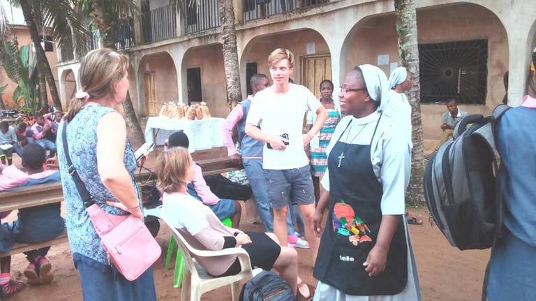 Missionary sisters speaking with community members during outreach event