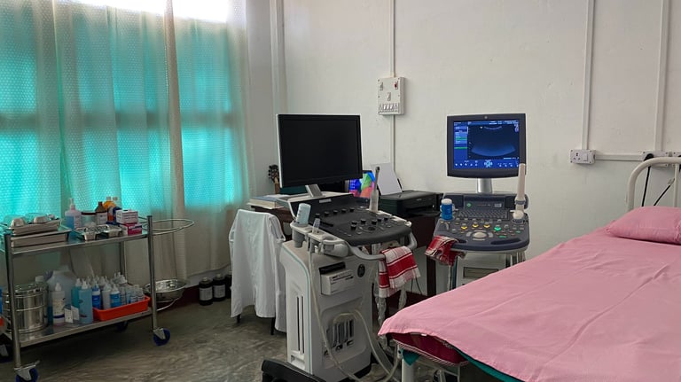 a hospital room with a bed and a computer monitor