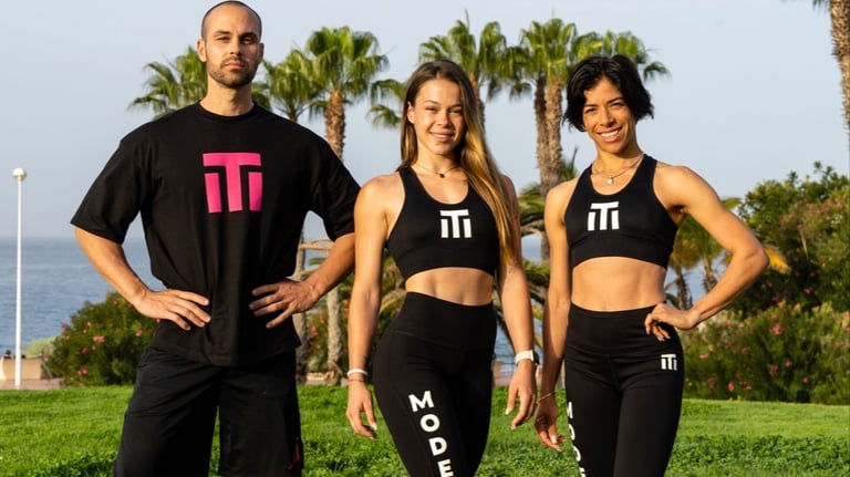 three people standing in front of a body of water