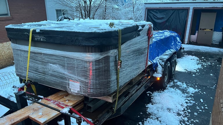 A trailer loaded with a hot tub and lumber for delivery 