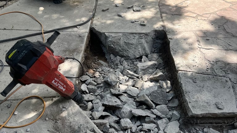 A jack hammer and broken up concrete patio Light demolition of