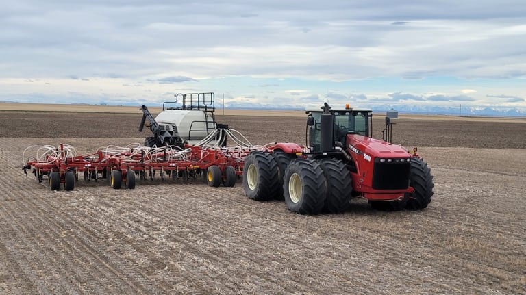 Versatile tractor pulling a Bourgault air seeder
