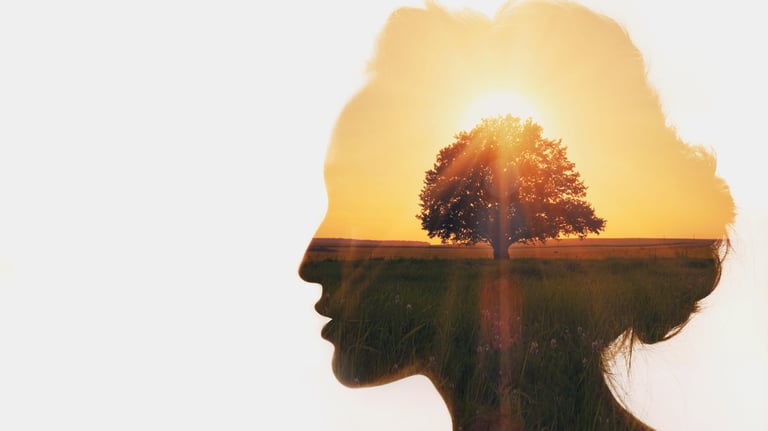a woman's profile with a tree in the background