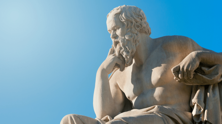 a statue of a man sitting on a bench