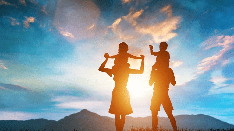 a man and woman holding hands up to the sky