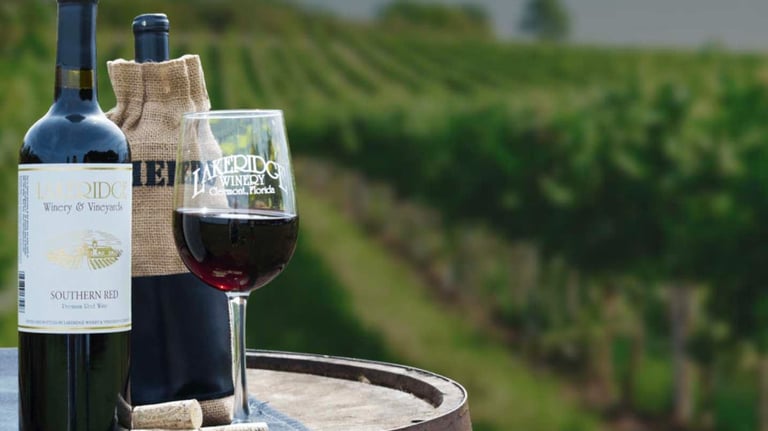 a wine glass and a bottle of wine on a barrel 