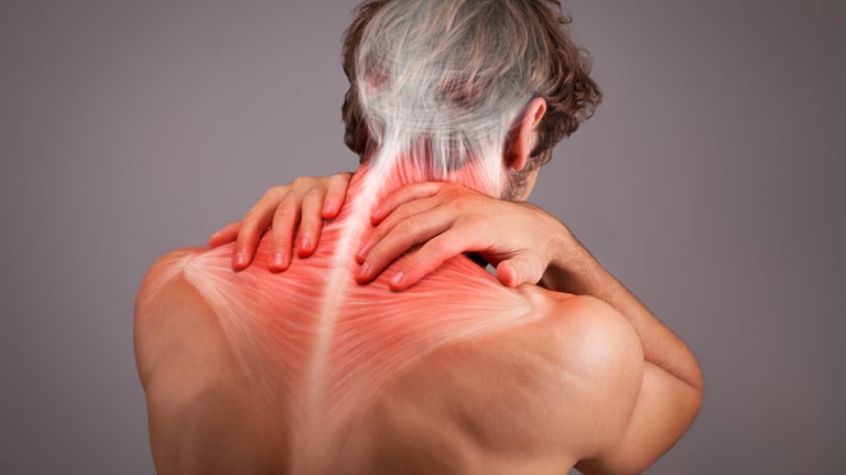 Man holding upper back showing neck and shoulder muscles, indicating muscle tightness / tension.