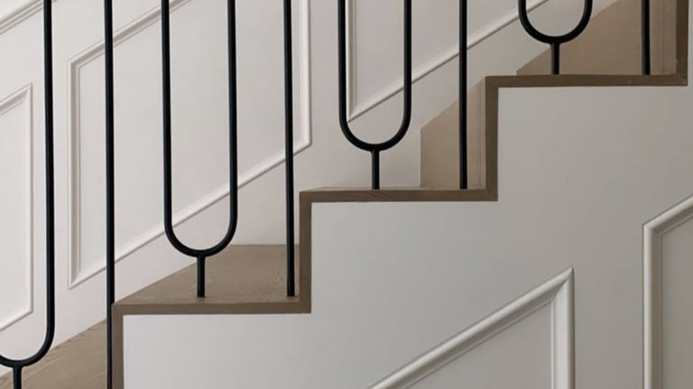 Custom staircase design with curved metal balusters and wood handrail for upscale interior