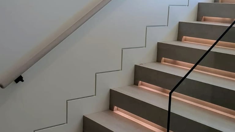 Contemporary staircase design with integrated lighting and minimalist zigzag wall detail