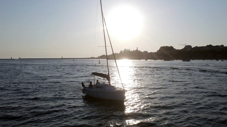 The sailboat Monark sailing on the Douro River at sunset