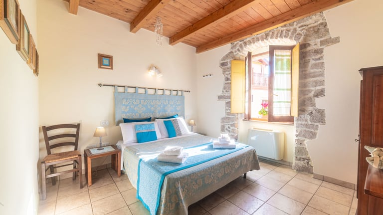 a bed room with a bed and a chair