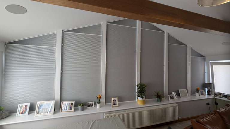 Shaped blackout honeycomb blinds fitted to angled windows in Aberdeen home