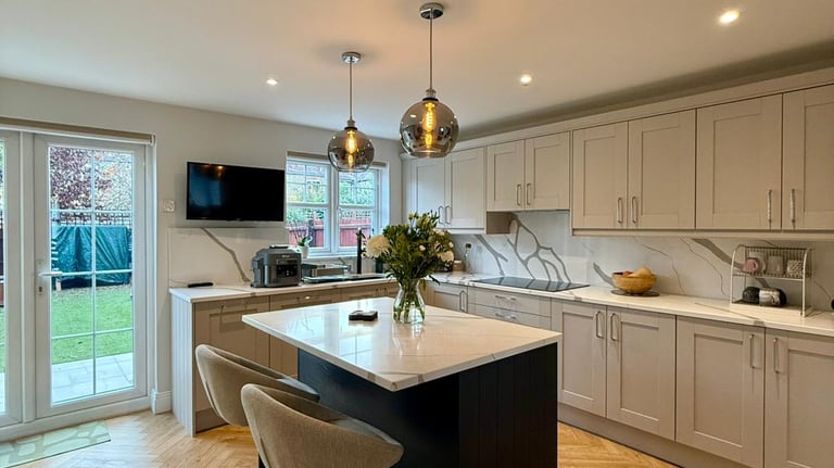 a kitchen with a large island and a bar stool